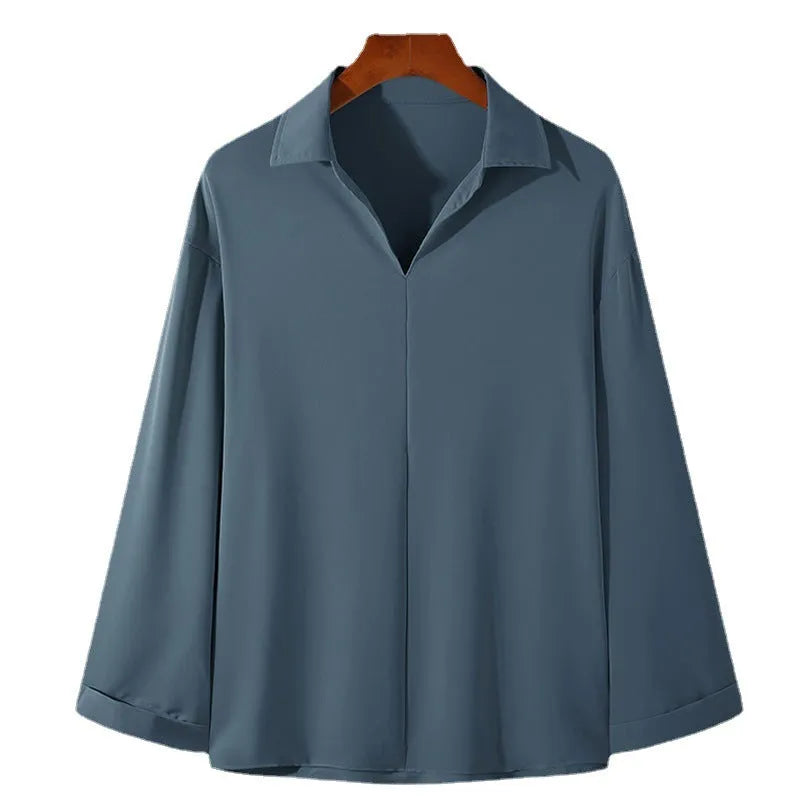 Man wearing a loose lapel pullover casual shirt in a light business style.