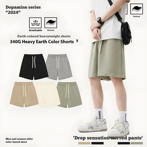 Baby boy and girl wearing loose-fitting cotton denim shorts in cream apricot colour.