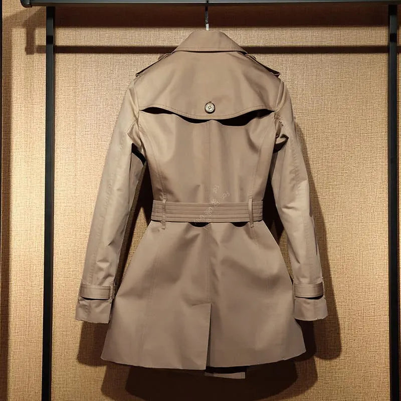Khaki double-breasted women's trench coat with long flight sleeves, shown on a hanger.