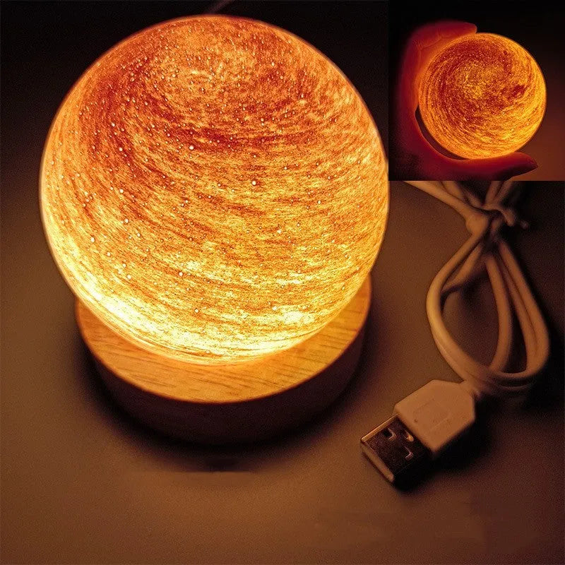 Planet night light with spherical design on base, USB cable connected, showing adjustable three-colour lighting