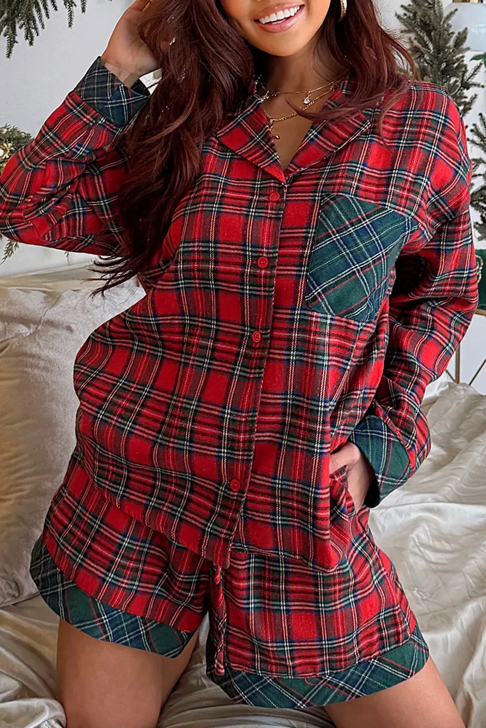 Red Christmas pyjama set with plaid contrast patches showing long sleeve shirt and matching shorts