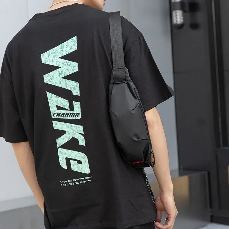 Black Oxford cloth crossbody waist pack with zippered opening showing interior organisation pockets