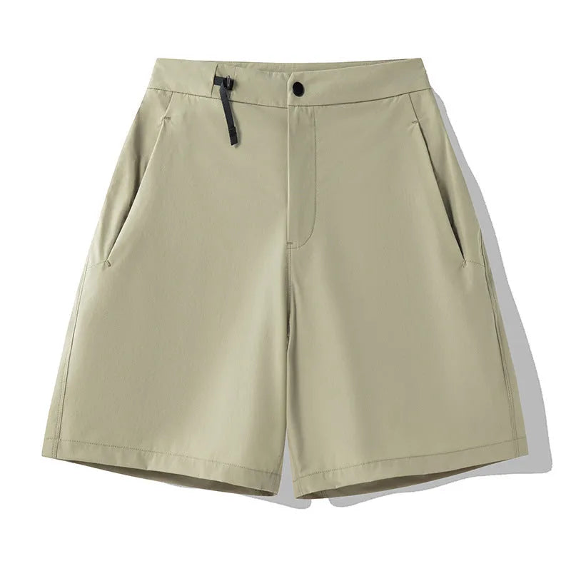 Men's solid colour quick-dry sports shorts with elastic waistband on a grey background.