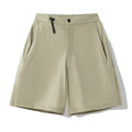 Men's solid colour quick-dry sports shorts with elastic waistband on a grey background.