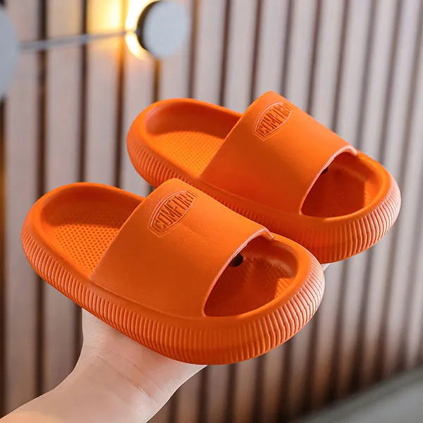 Mixed colour children's EVA slippers with non-slip soles in sizes for ages 24-35.