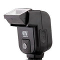 Silver hot shoe camera flash unit with head tilted upwards, shown mounted on an SLR camera