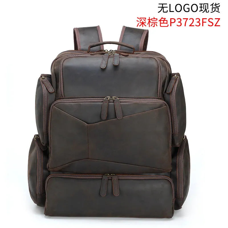 Dark brown retro crazy horse leather men's backpack open to show 17-inch laptop compartment and internal pockets.