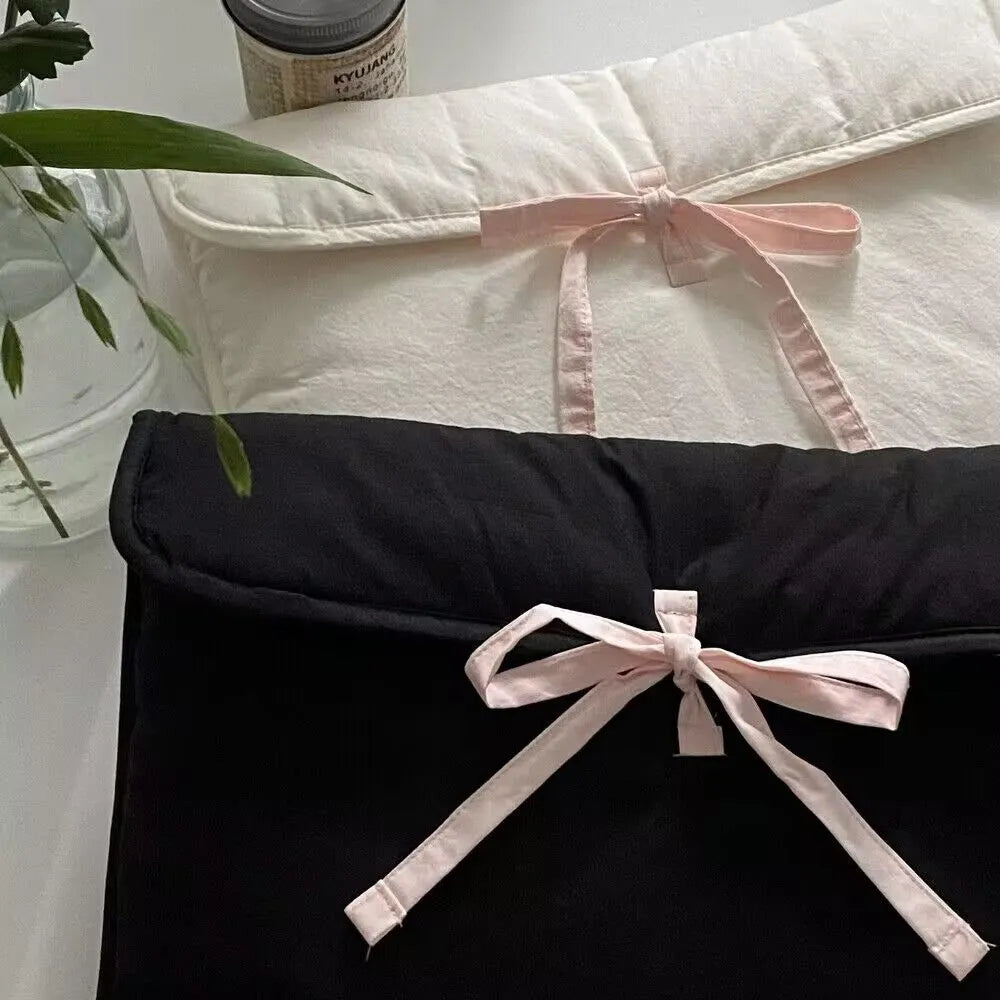 Black and white quilted women's laptop bag with a ballet bow and striped pattern.