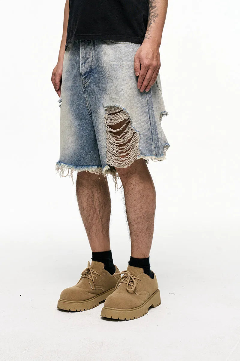 Light blue washed men's denim shorts with a baggy wide leg fit on a mid waist.
