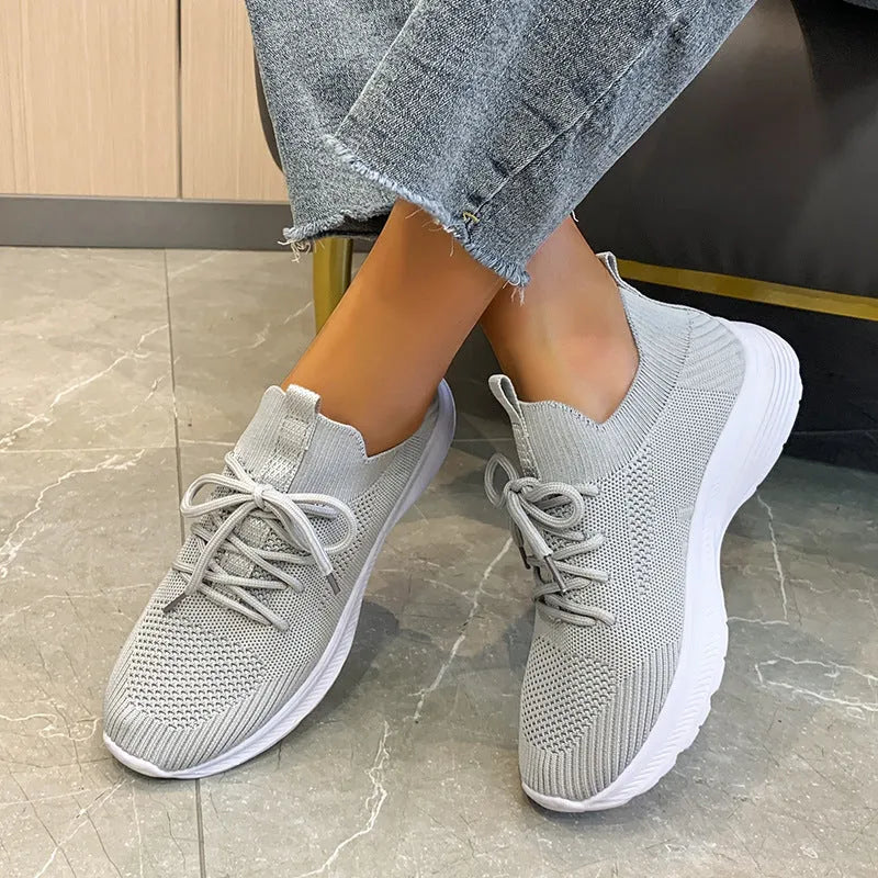 Women's low-top mesh running shoes in creamy white with a rubber sole and round toe.