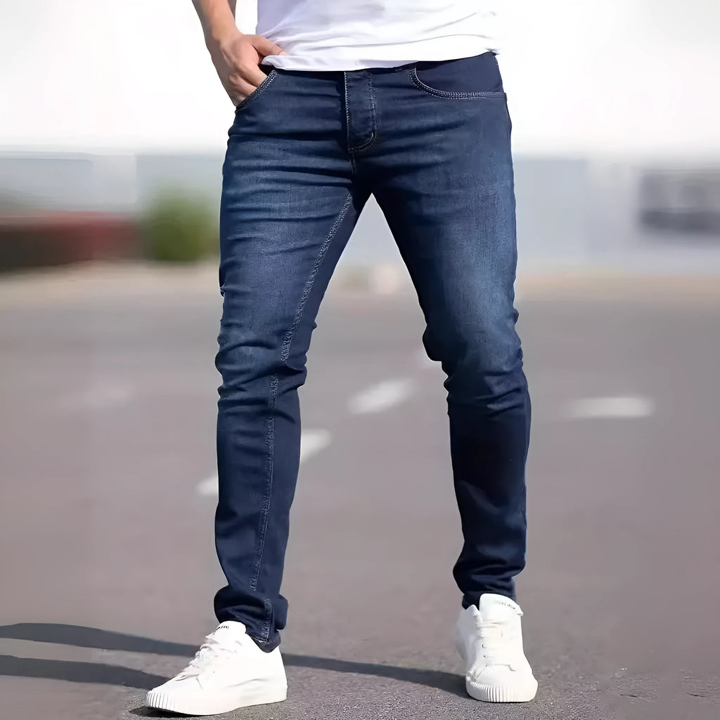 Men's dark blue slim fit casual jeans with mid waist and zipper fly opening