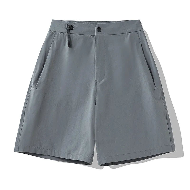 Men's solid colour quick-dry sports shorts with elastic waistband on a grey background.