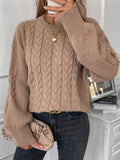 Beige women's loose casual sweater with round neck and a subtle twist design detail on the front