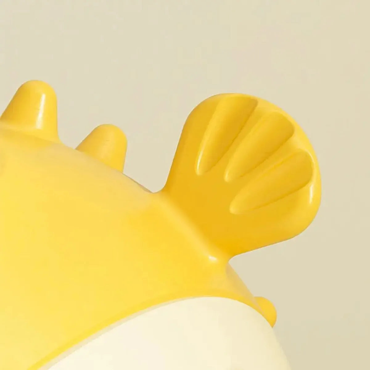 Yellow fish-shaped dog chew toy with textured surface for teeth cleaning