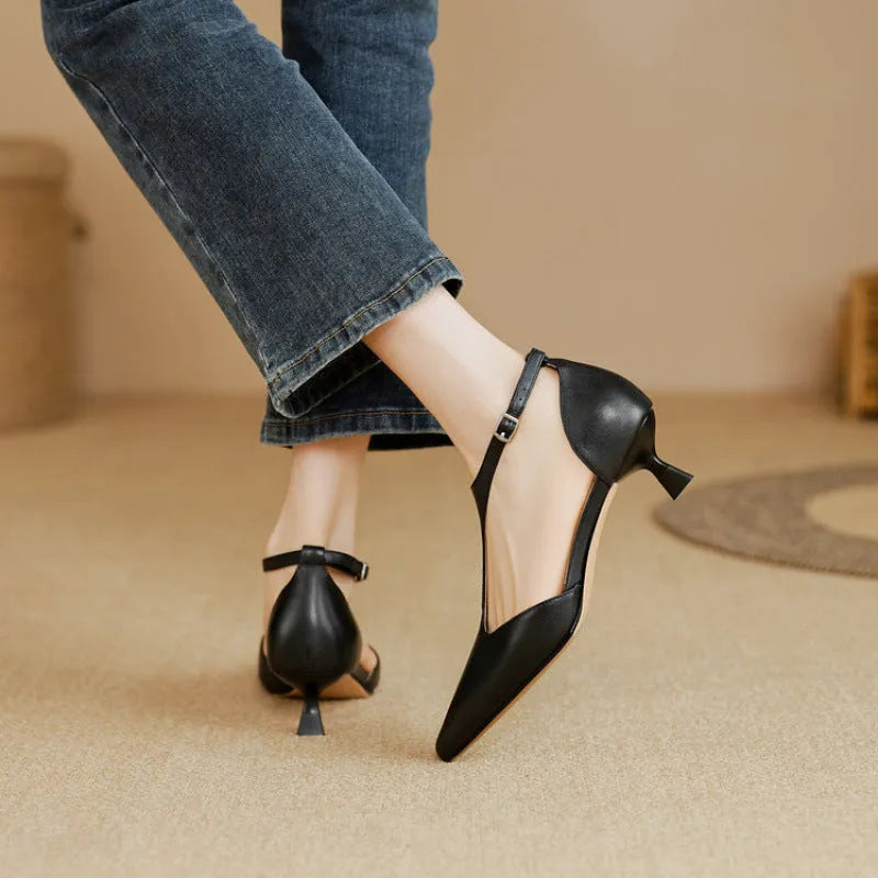 Women's vintage brown high heel shoe with a pointed toe and cowhide upper