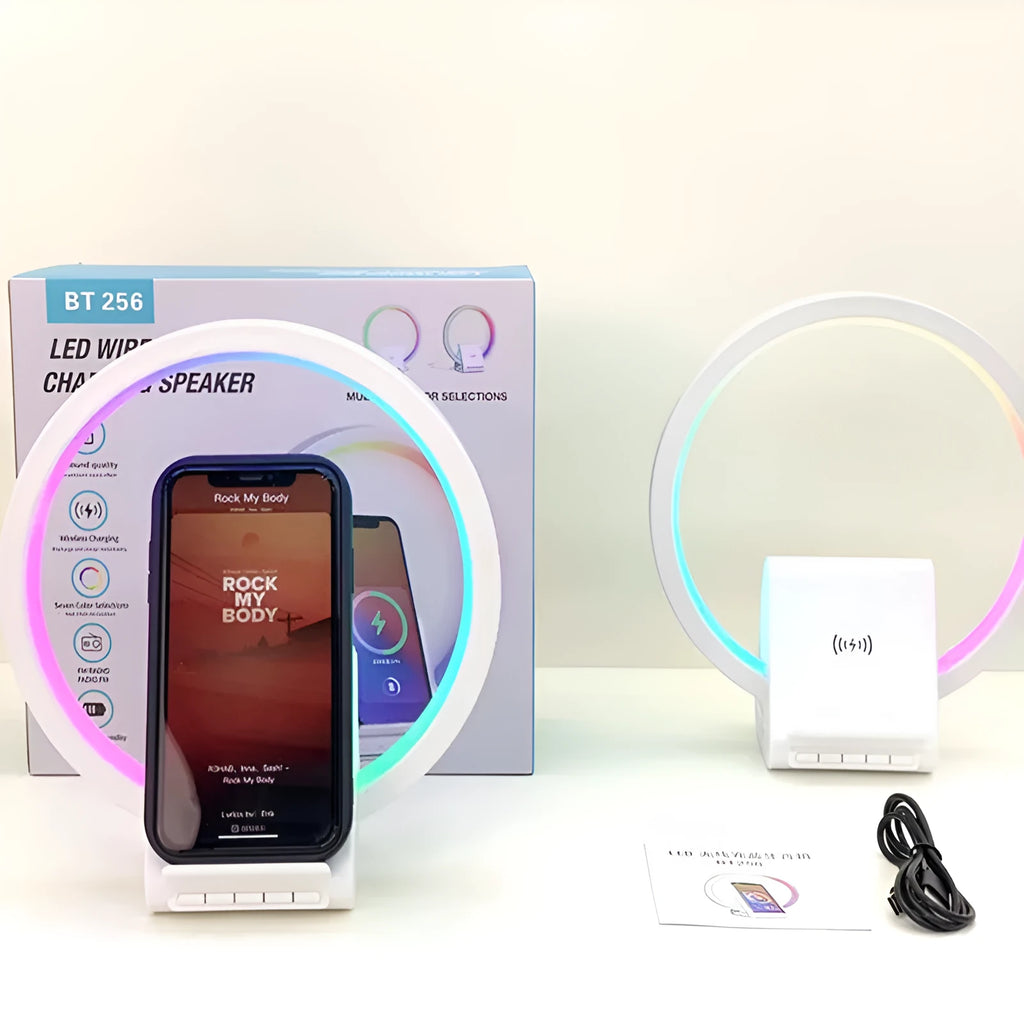 White smart Bluetooth speaker with wireless charging pad, ambience light, and card slot on a desk