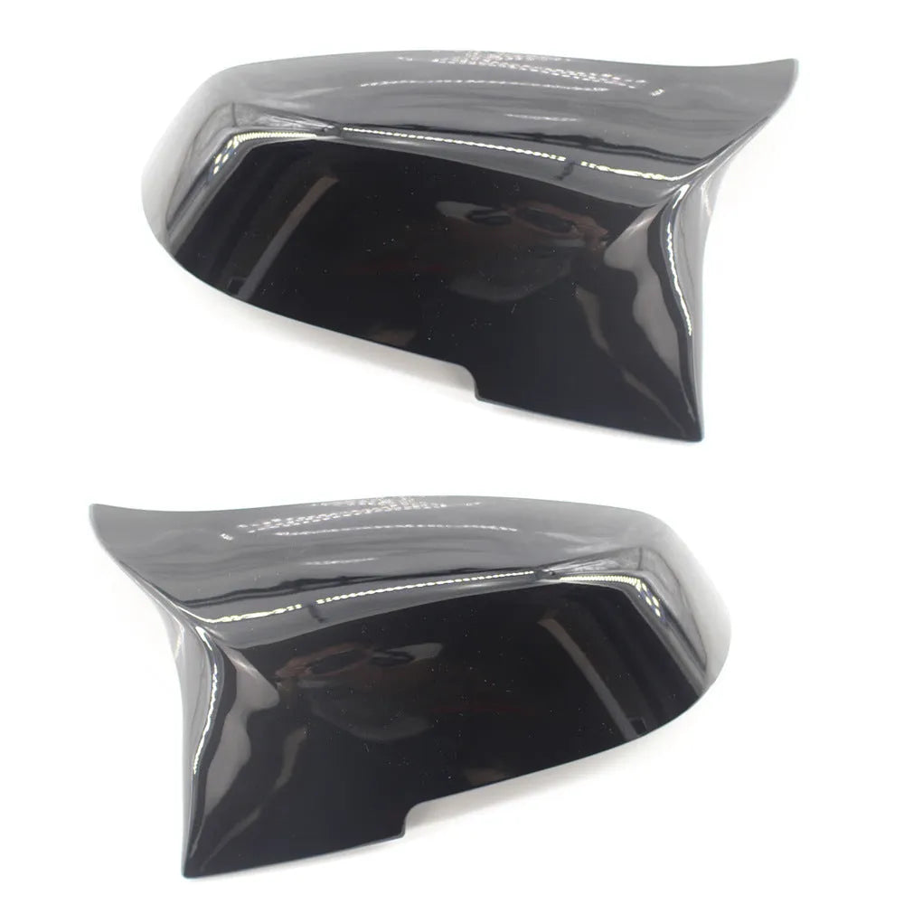 Pair of paint bright black BMW rear-view mirror replacement shells for 3 Series and 4 Series models.