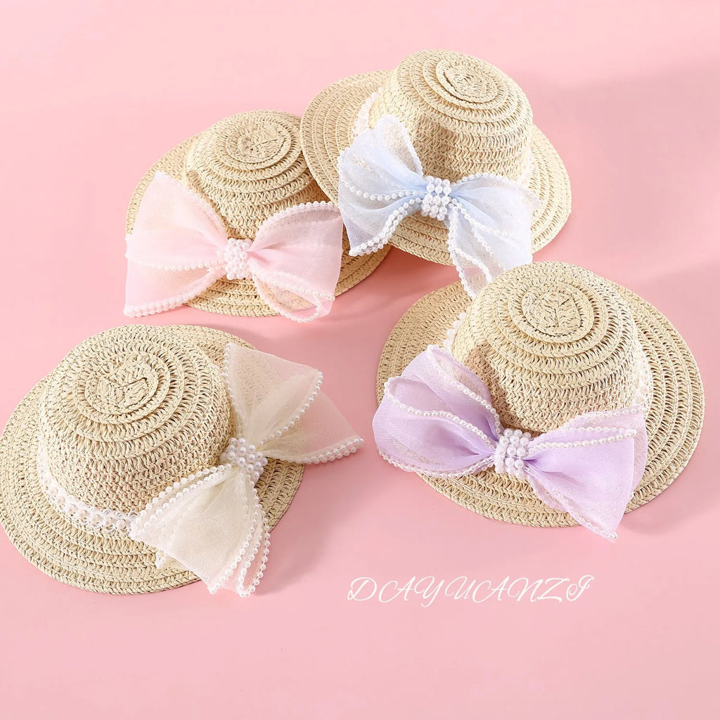 Pet cat wearing princess-style straw hat with woven pearl bow decoration in lafite leaves material