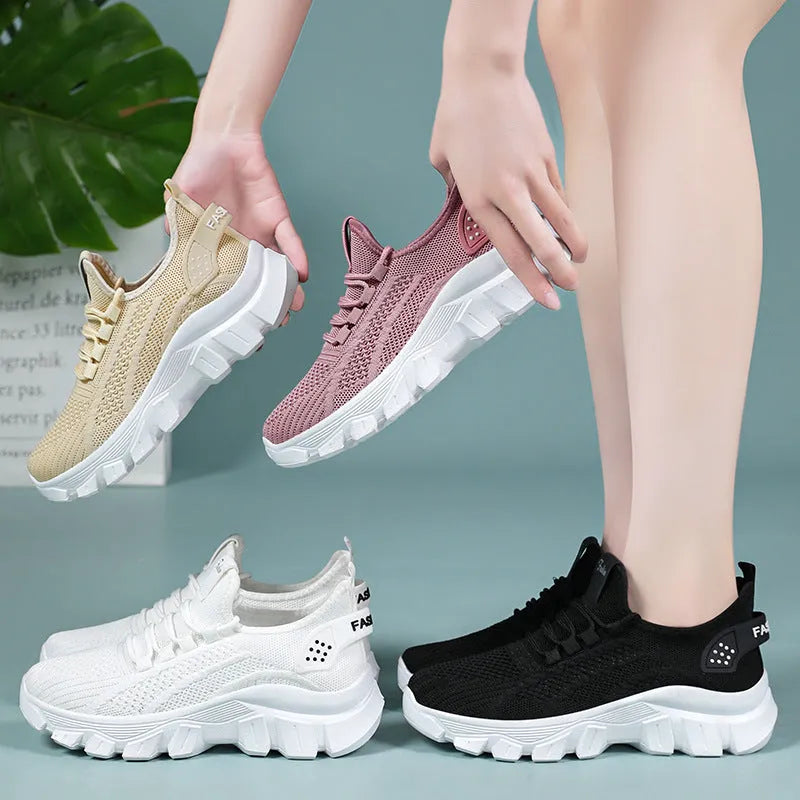 Women's white Flyknit running sneaker with thick PVC sole and lace-up front on a neutral background.