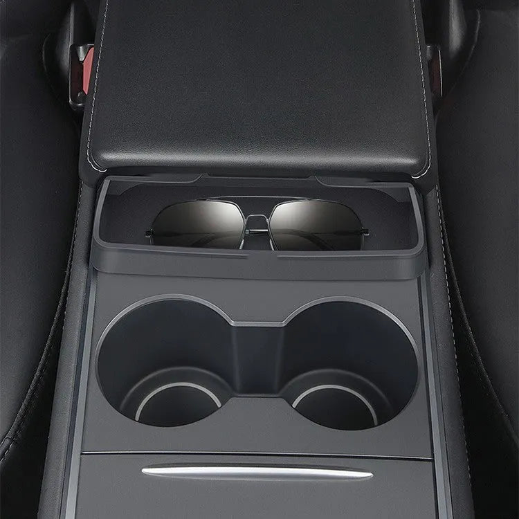 Black silicone glasses storage case installed in a Tesla Model 3 or Y centre console armrest.