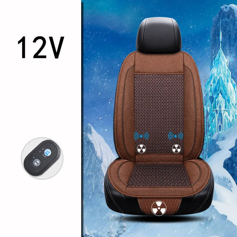 Square black car seat ventilation cushion with power cord, shown on a car seat.