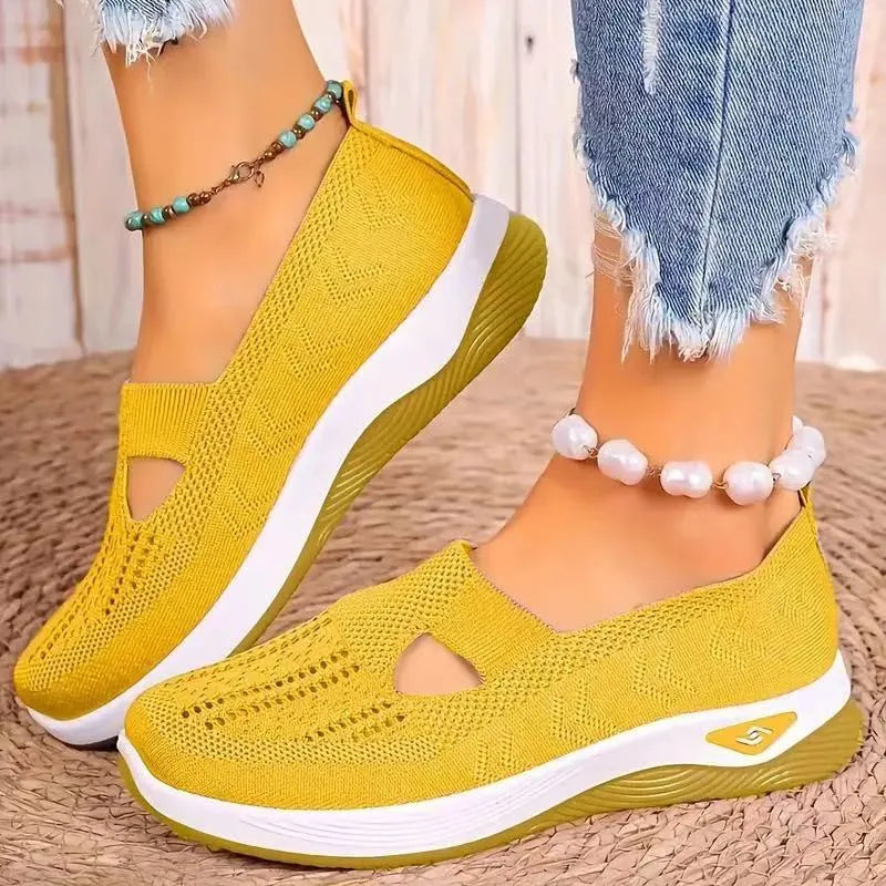 Women's black casual mesh shoes with T-strap and flat soft sole.