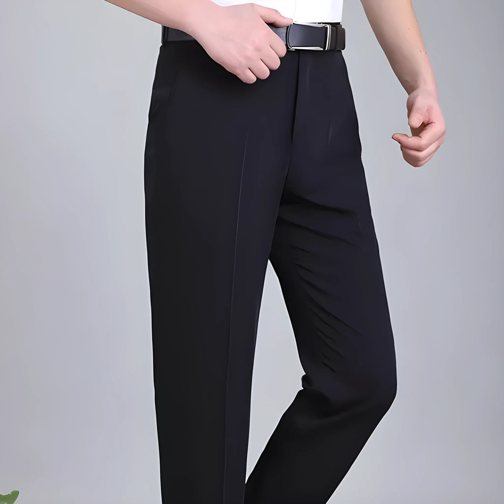 Man wearing dark blue straight-leg suit pants with a high waist, made from a non-ironing mulberry silk blend fabric.