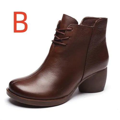 Brown women's leather Martin boots with a thick heel and round toe on a white background.