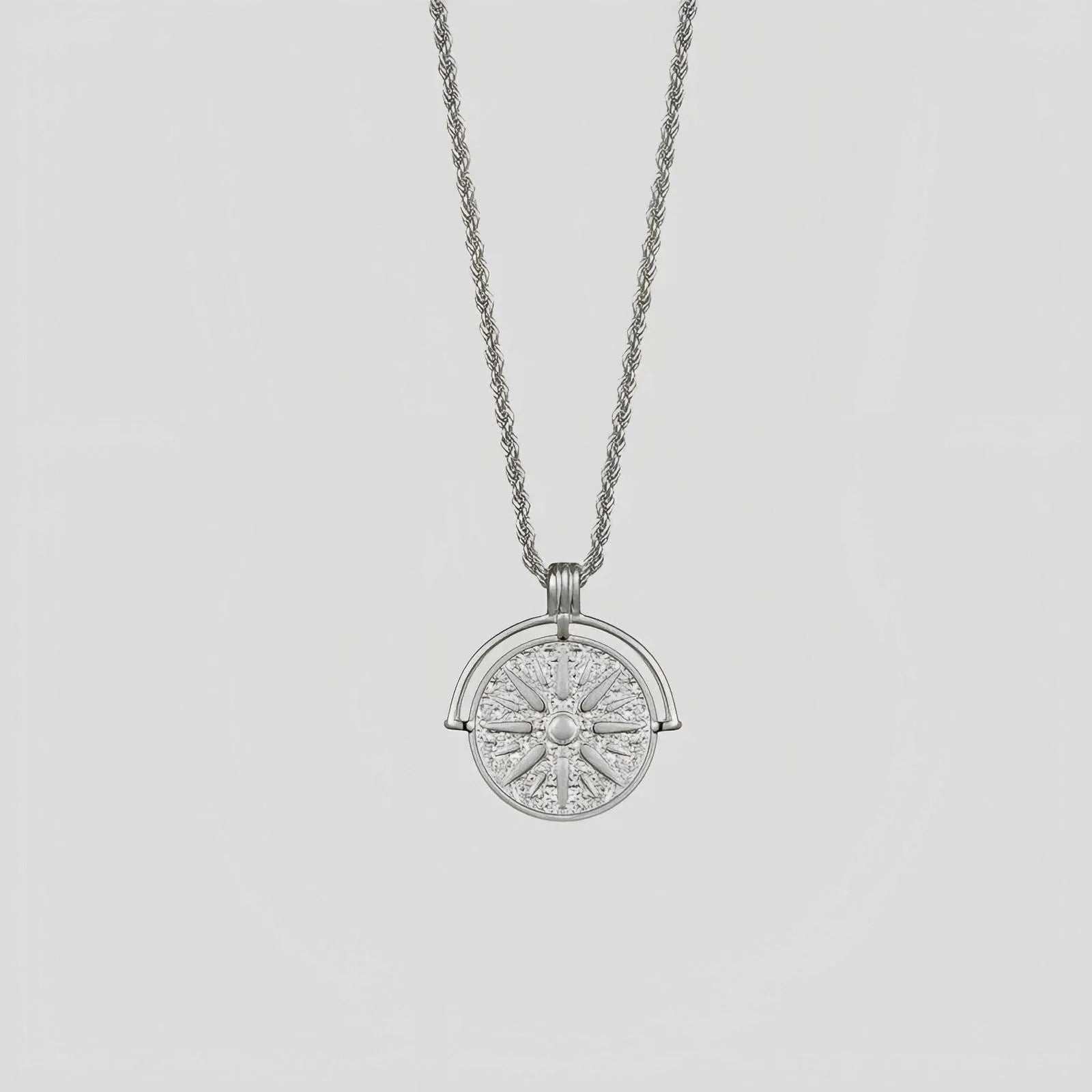 Gold stainless steel sunflower pendant necklace with geometric embossed design on hemp chain