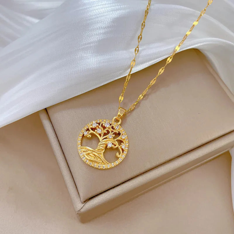 Gold-plated necklace with mother of pearl lucky tree pendant and rhinestone zircons on an adjustable chain.