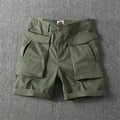 Men's straight-leg cotton cargo shorts with stretch in army green, shown with multiple pockets.