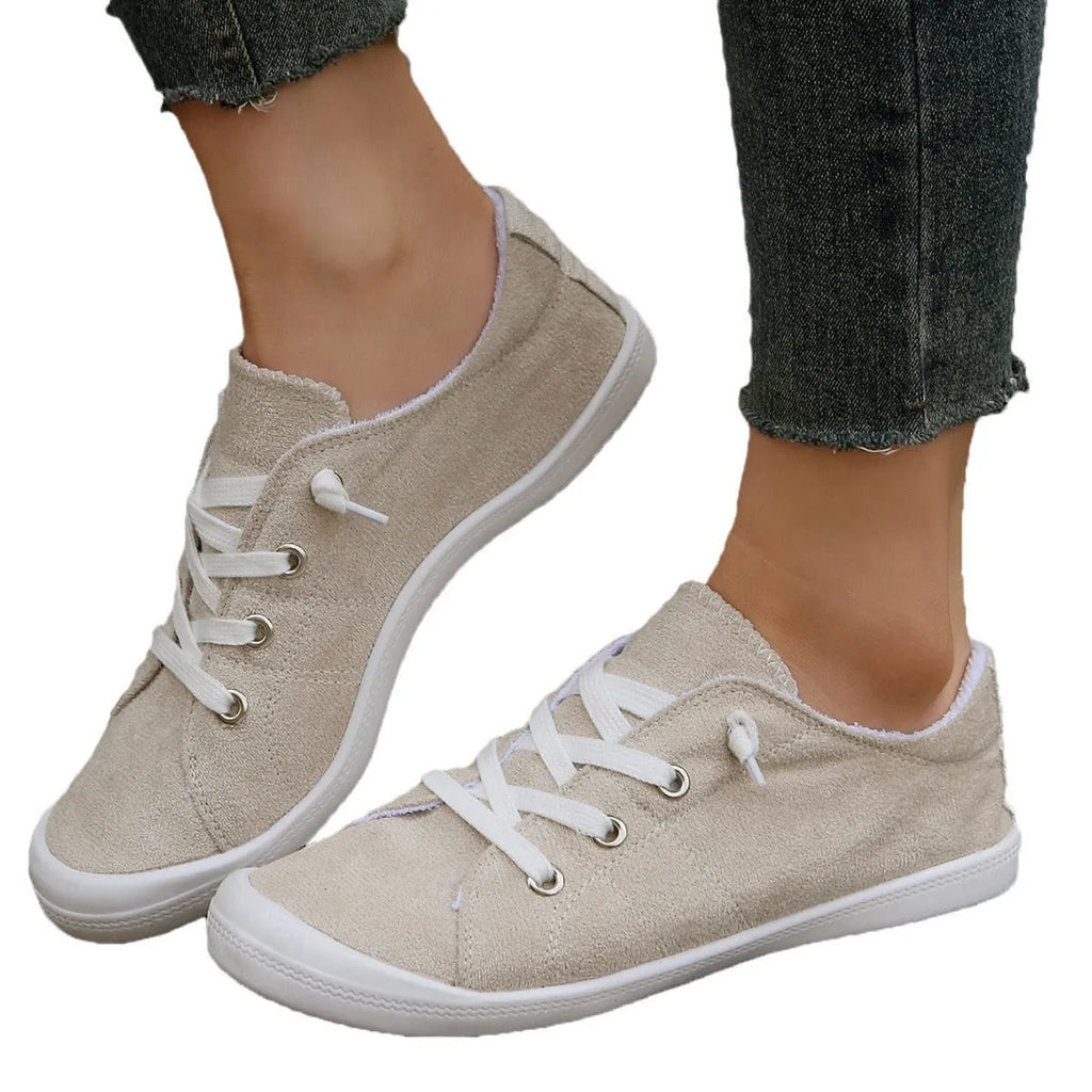 Women's creamy white low-top casual sneakers with fabric upper and rubber sole