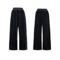 Men's black polyester sports suit with hooded short sleeve jacket and matching trousers laid flat