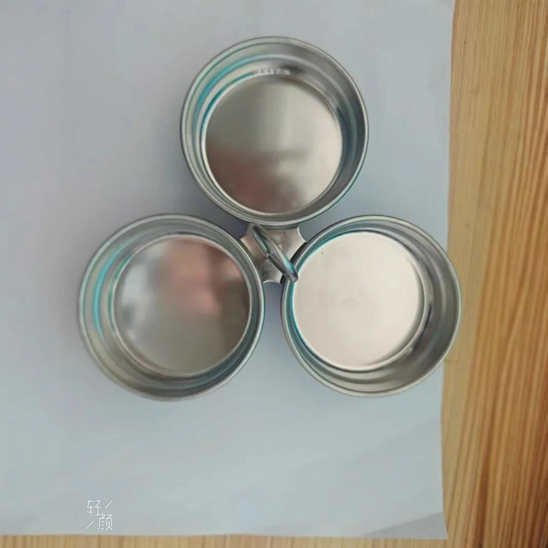 Small stainless steel heart-shaped egg steamer or cooker on a kitchen counter.