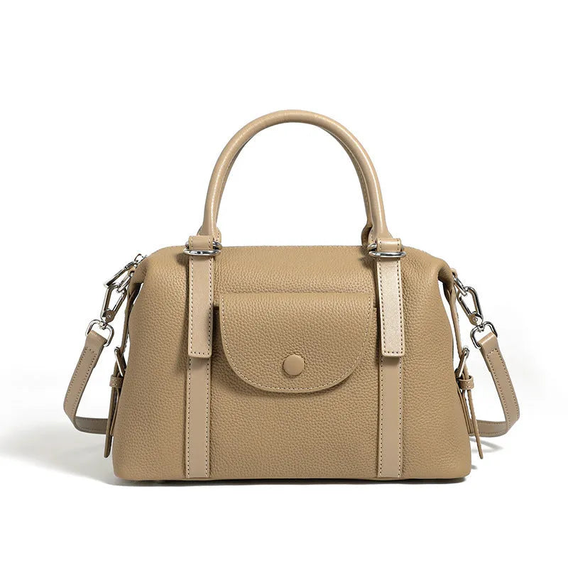 Black genuine leather ladies handbag with single shoulder strap, showing contrast lock and stitching.