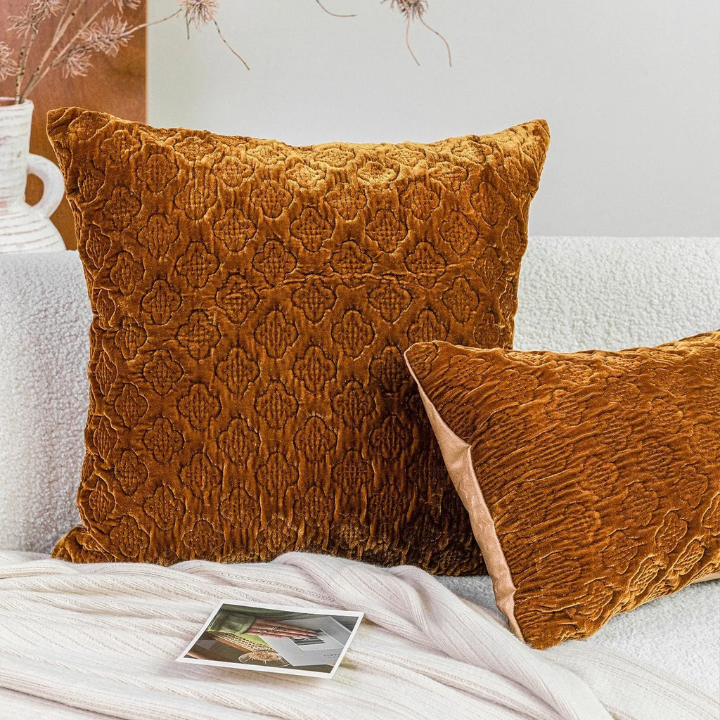 Brown gold antique style three-dimensional quilted cushion pillow on a sofa.