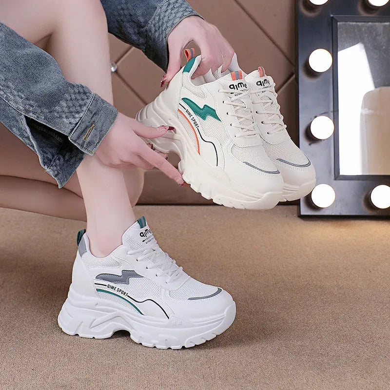 Women's beige and white height increasing dad shoes with mesh upper and cross shoulder straps.