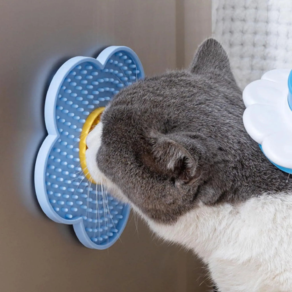 A blue flower-shaped silicone lick mat for pets with four white suction cups on the underside.