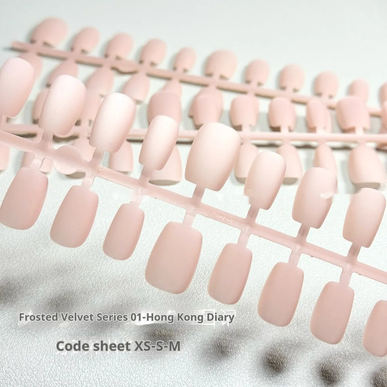 Cat's Eye Aurora false nails with frosted velvet pattern in short ladder shapes on display