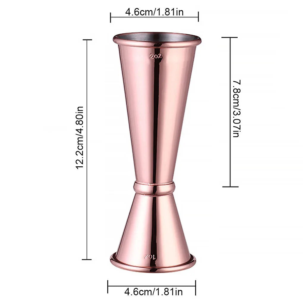Double-headed stainless steel measuring cup and shaker on a bar counter for cocktail preparation