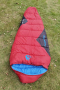 Outdoor cotton sleeping bag in Army Green with its compression sack, sized 230cm long.