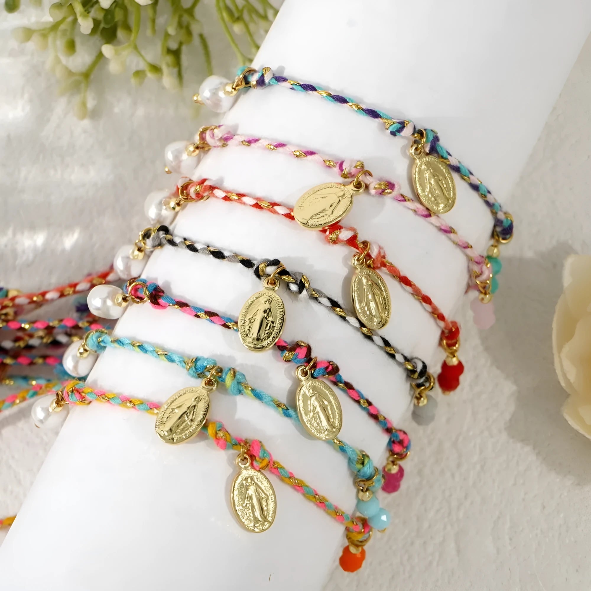 Close-up of a hand-woven colourful braided rope bracelet with an adjustable strap tag, showing ethnic style design.