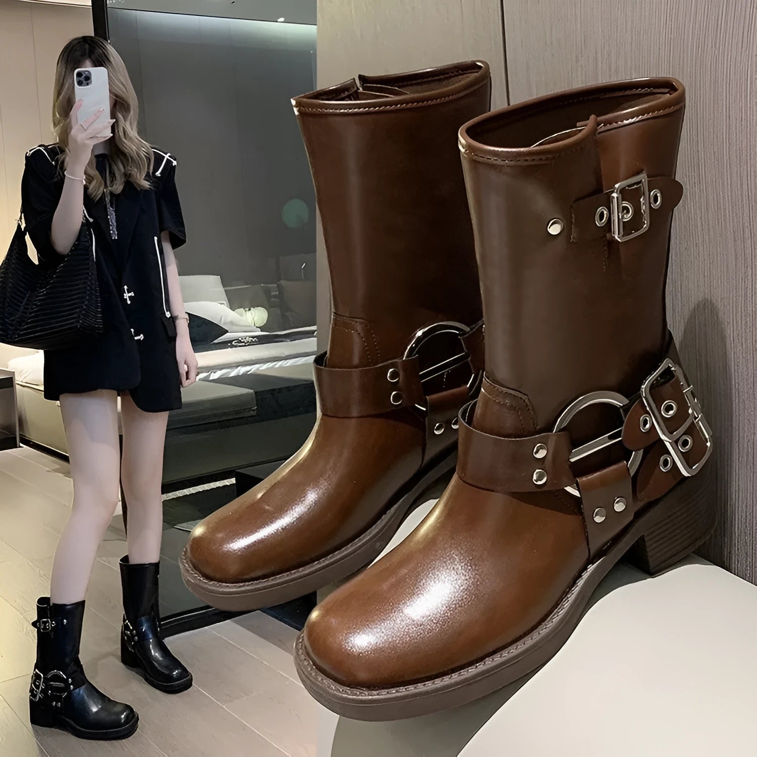 Women's black platform boot with belt buckle detail on middle calf.