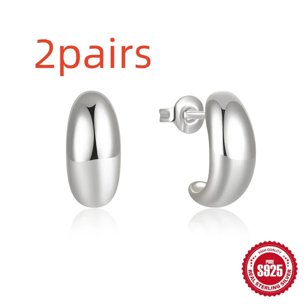 C-shaped sterling silver stud earrings with high polish gloss finish in gold colour