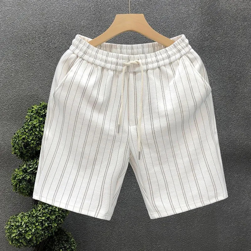 Men's black and white striped fleece-lined casual shorts with an ankle-banded cuff on a hanger.