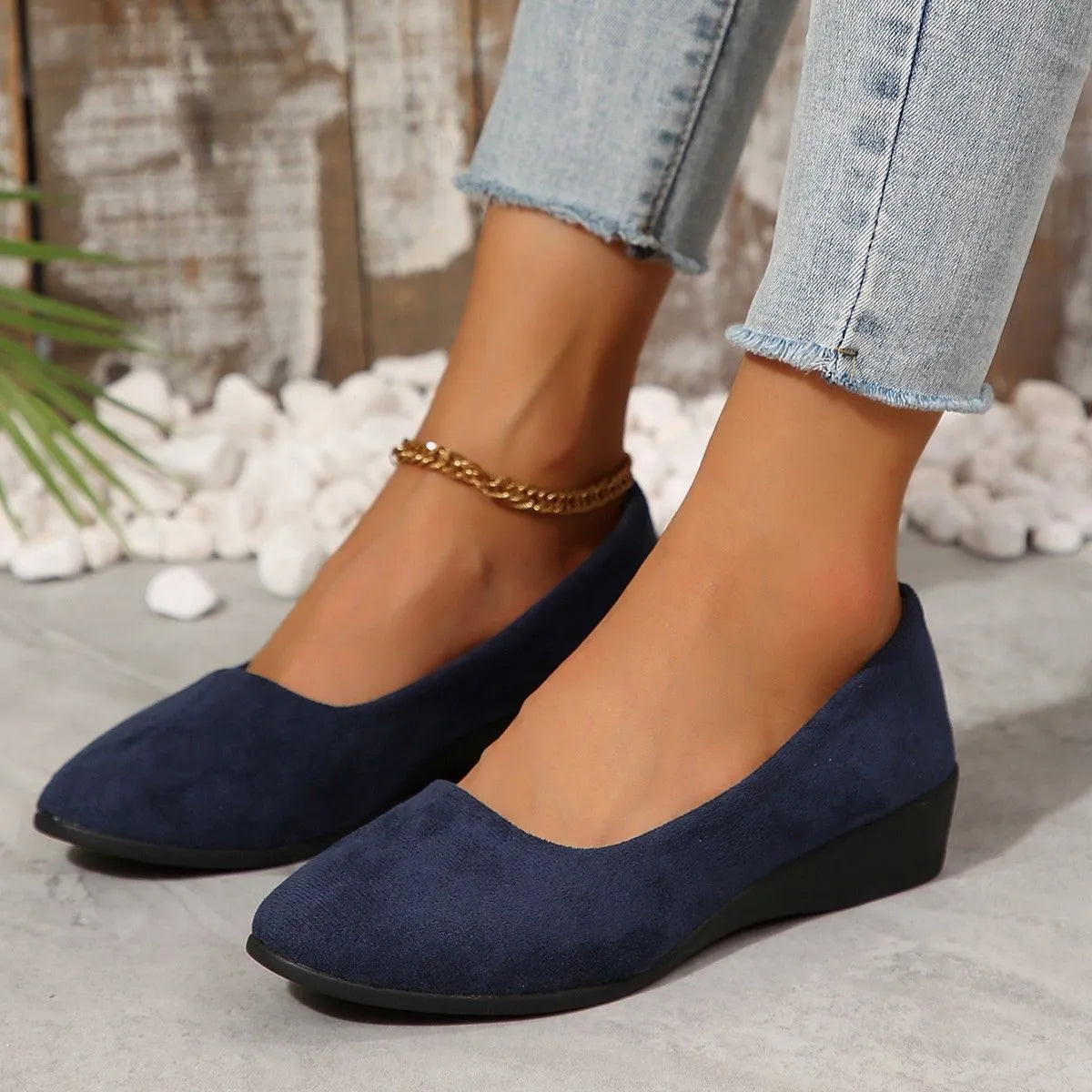 Women's pointed toe wedge pumps in suede with a low heel and shallow mouth opening.