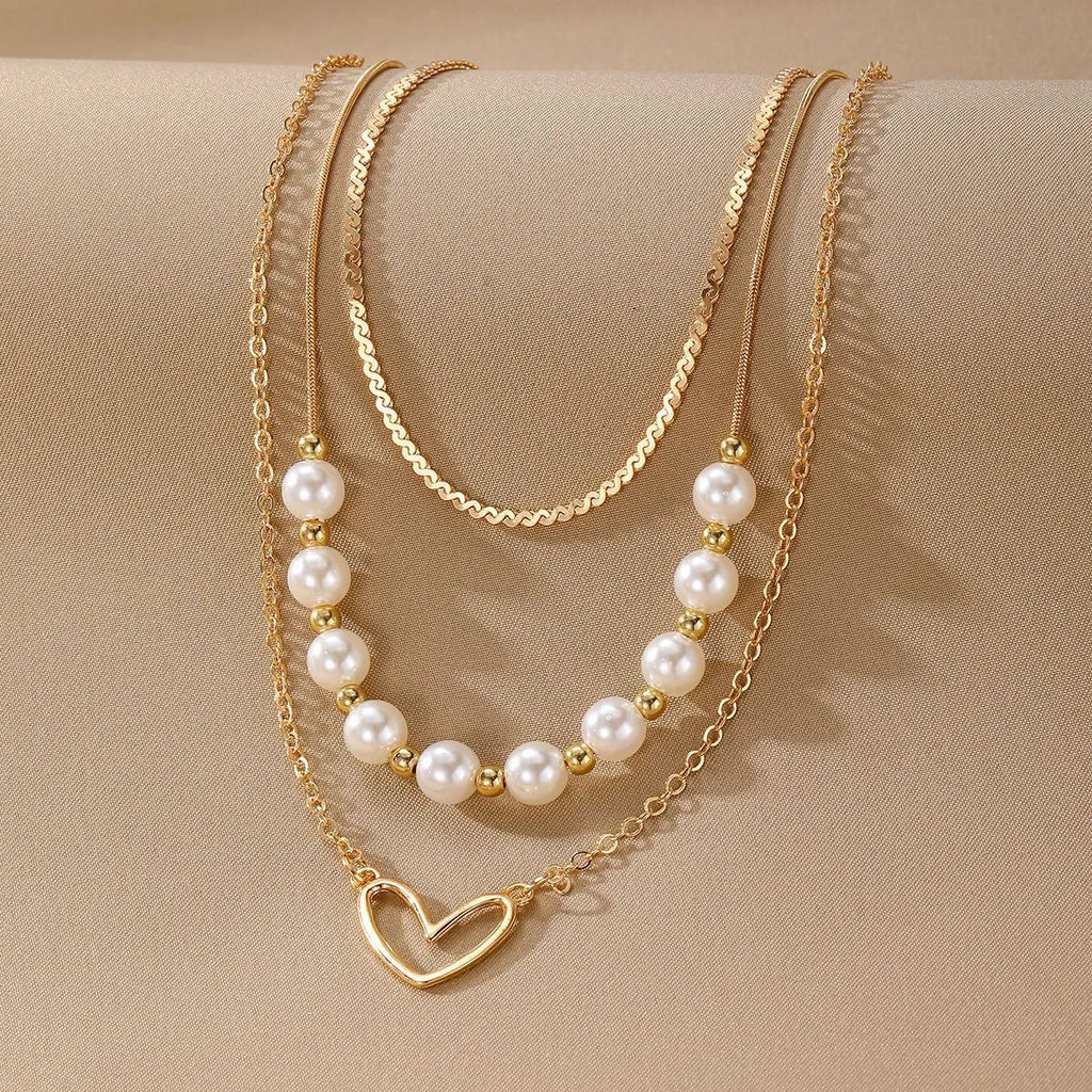 Vintage gold-tone heart pendant necklace with pearl chain and adjustable length