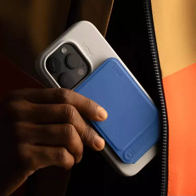 Magnetic mobile phone holder and case in leather with built-in stand, shown in grey.