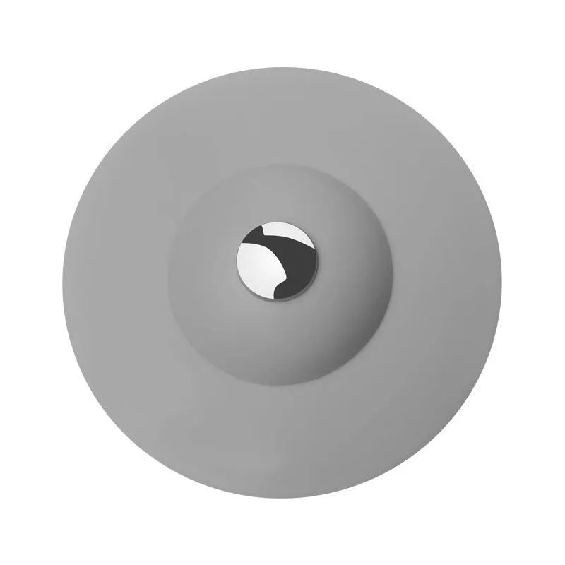 UFO-style silicone press sink drain cover in white on a modern kitchen sink