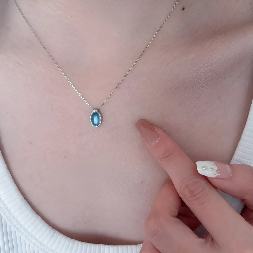 Navy blue geometric water drop pendant necklace with platinum-plated finish on adjustable chain